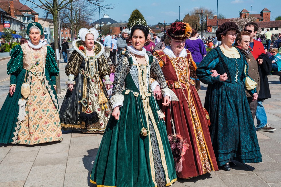 A photograph of modern day women wearing Tudor costumes.
