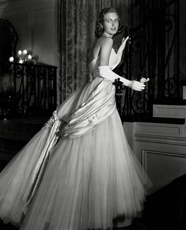 Chicago debutante Joan Peterkin in strapless, tulle and white satin Dior dress, with white gloves. (Photo by Horst P. Horst/Condé Nast via Getty Images)