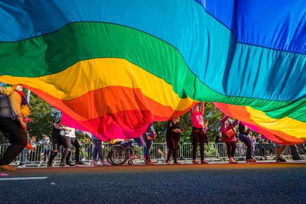 People march with a large rainbow flag in Reykjavik, Iceland. (Image by Photolibrary / Getty Images Plus)