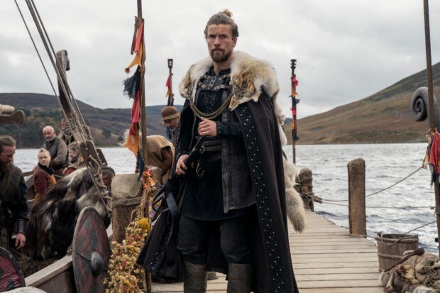 Harald Sigurdsson stands on a dock in Kattegat holding a weapon