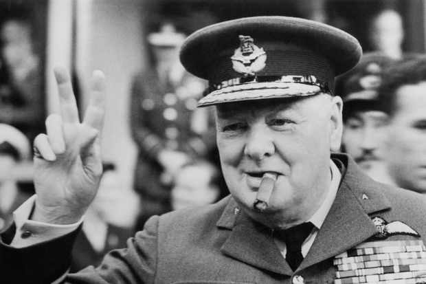 Winston Churchill gives his famous v-sign as he opens the new headquarters of 615 (County of Surrey) Squadron of the RAAF (Royal Auxiliary Air Force) at Croydon, 1948. (Photo by Central Press/Hulton Archive/Getty Images)